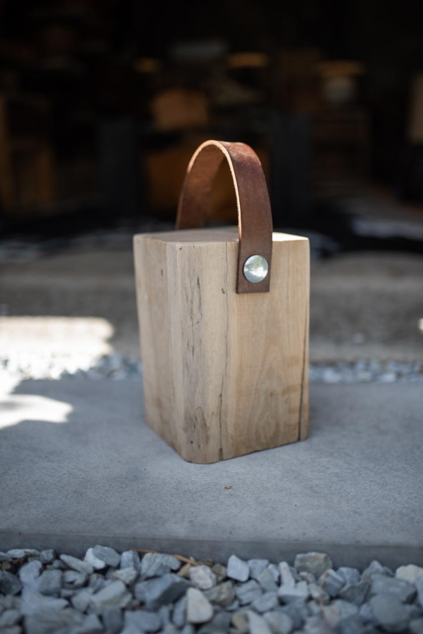 Wooden block Doorstoppers with leather straps.