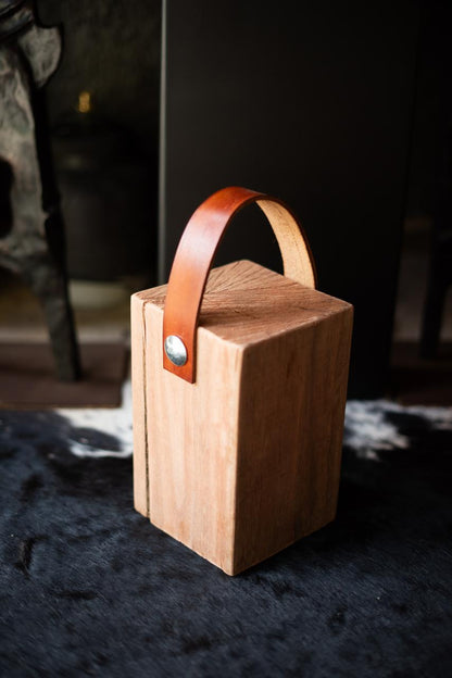 Wooden block Doorstoppers with leather straps.