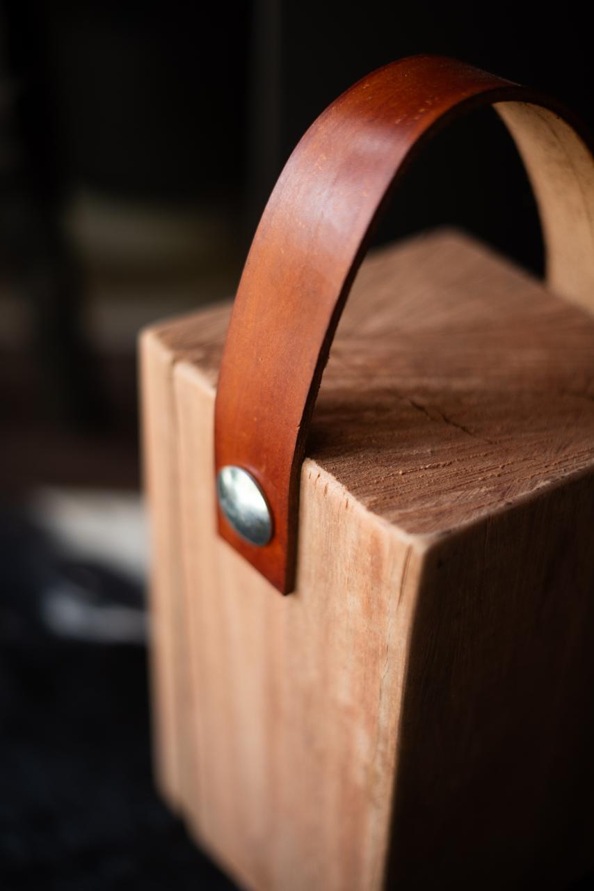 Wooden block Doorstoppers with leather straps.